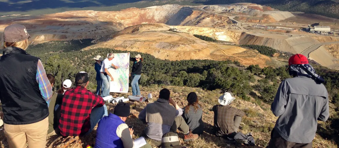 group of students at an outlook over a mine