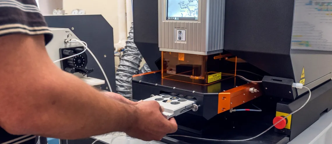 scientist loading sample into a laser